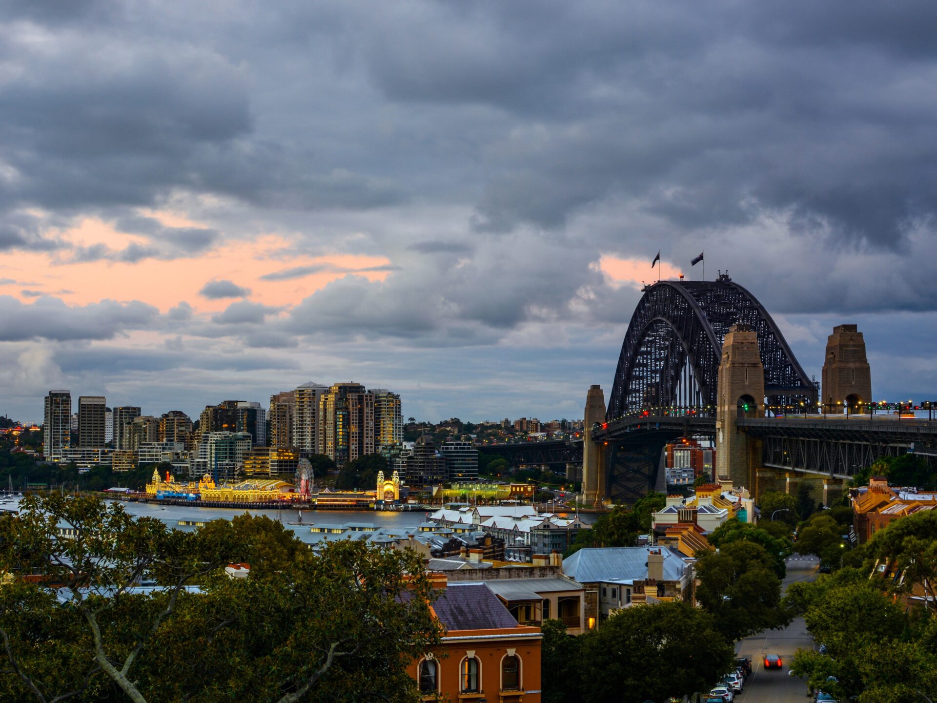 Sonnenuntergang über Sydney Harbour Bridge vom Observatory Hill Park mit Blick auf Hafen und Skyline. Bester Spot für Harbour Views und magische Sonnenuntergänge in Sydney.
